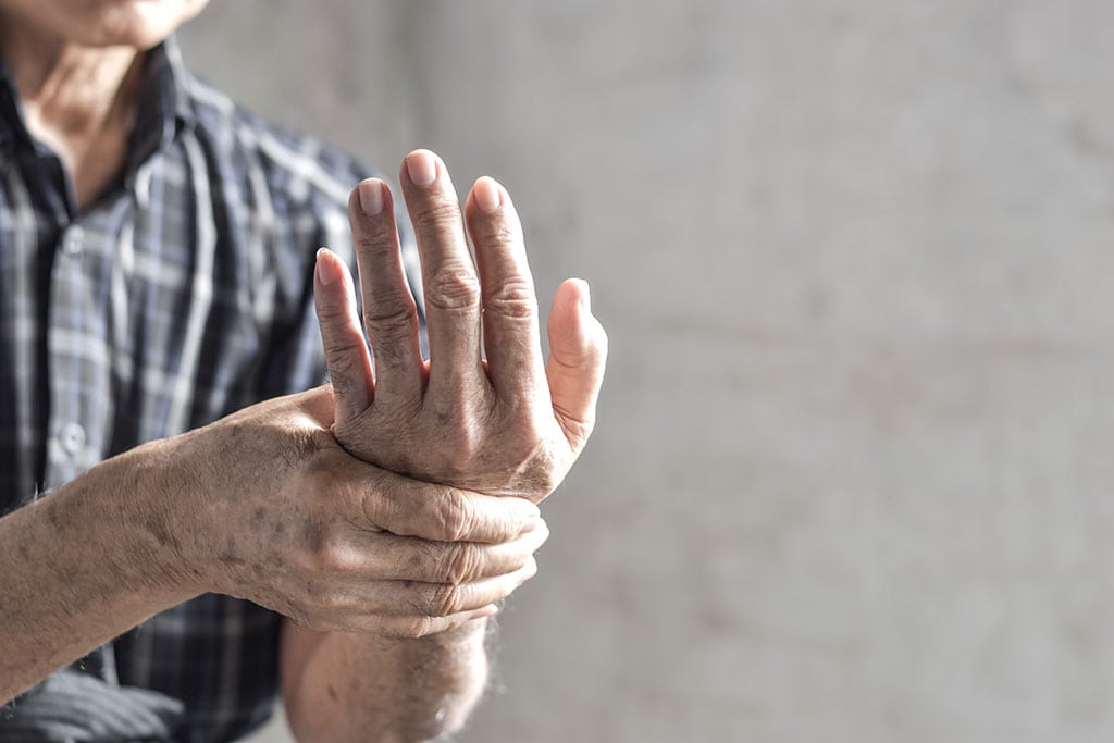 Elderly Man Holding His Hand Dealing With the Pain of Osteoarthritis.